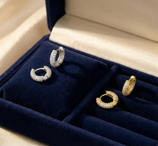 Pair of hoop earrings in a jewelry box with blue interior