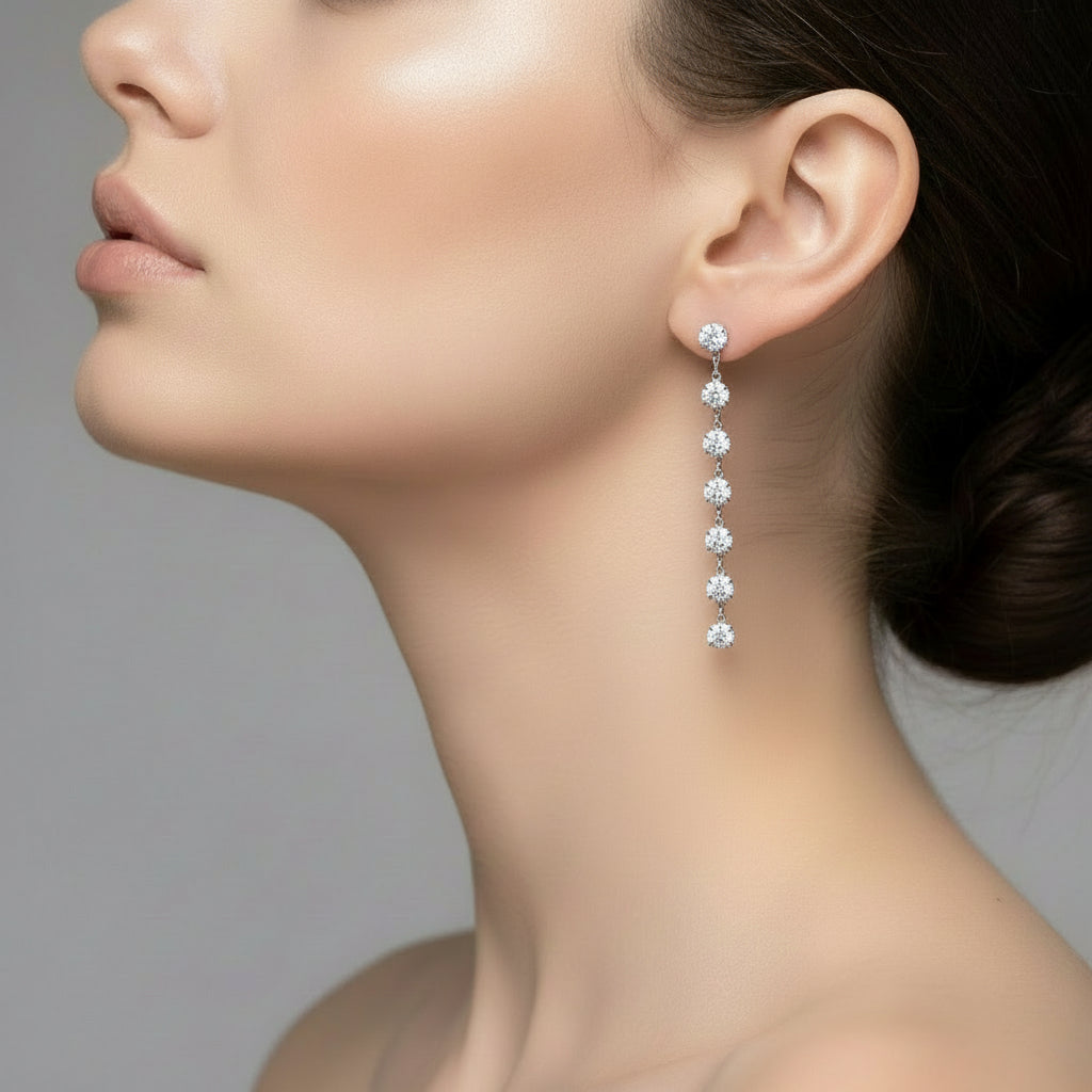 Close-up of a woman wearing a diamond earring against a neutral background