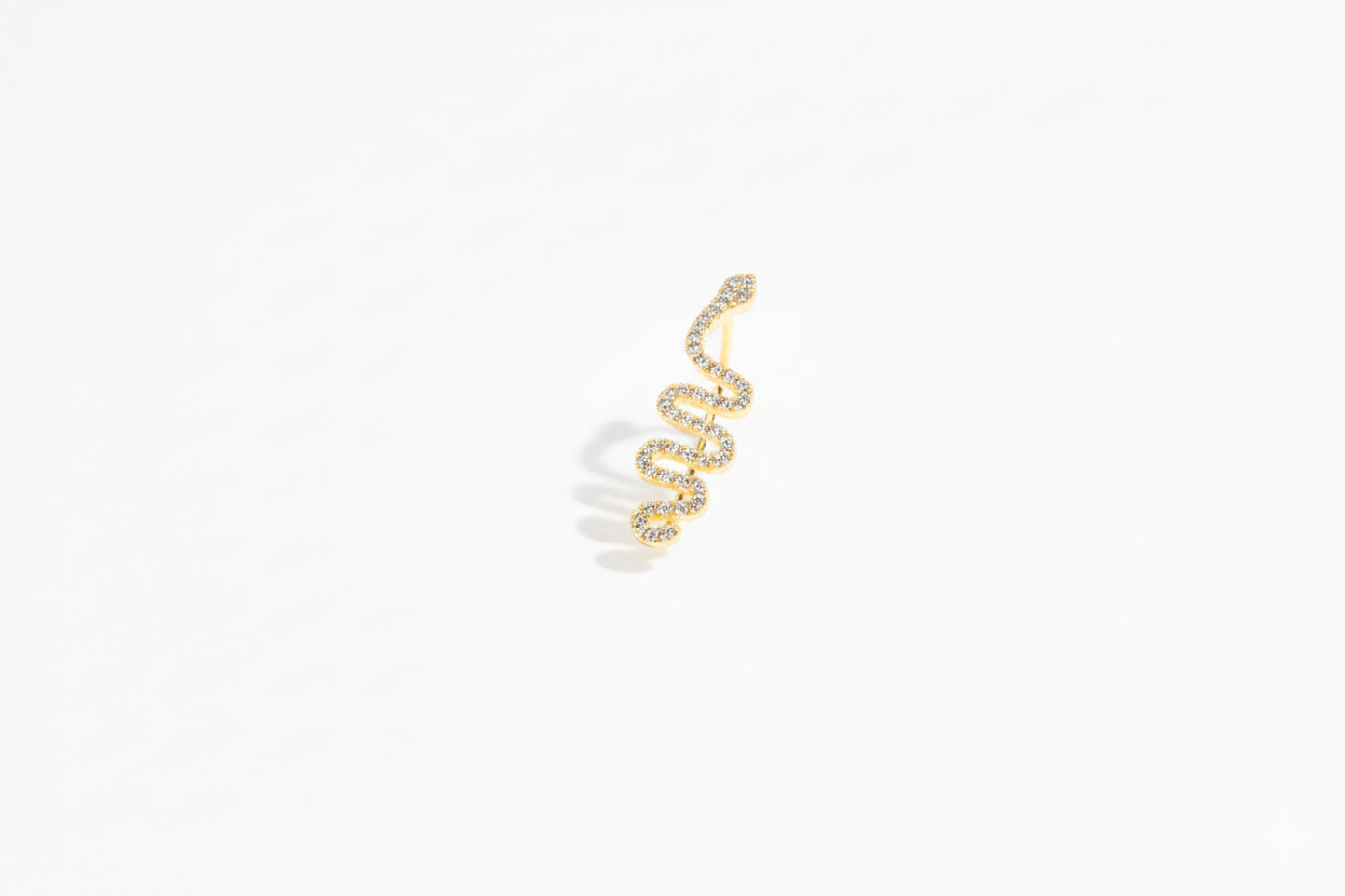 Gold snake earring on a white background