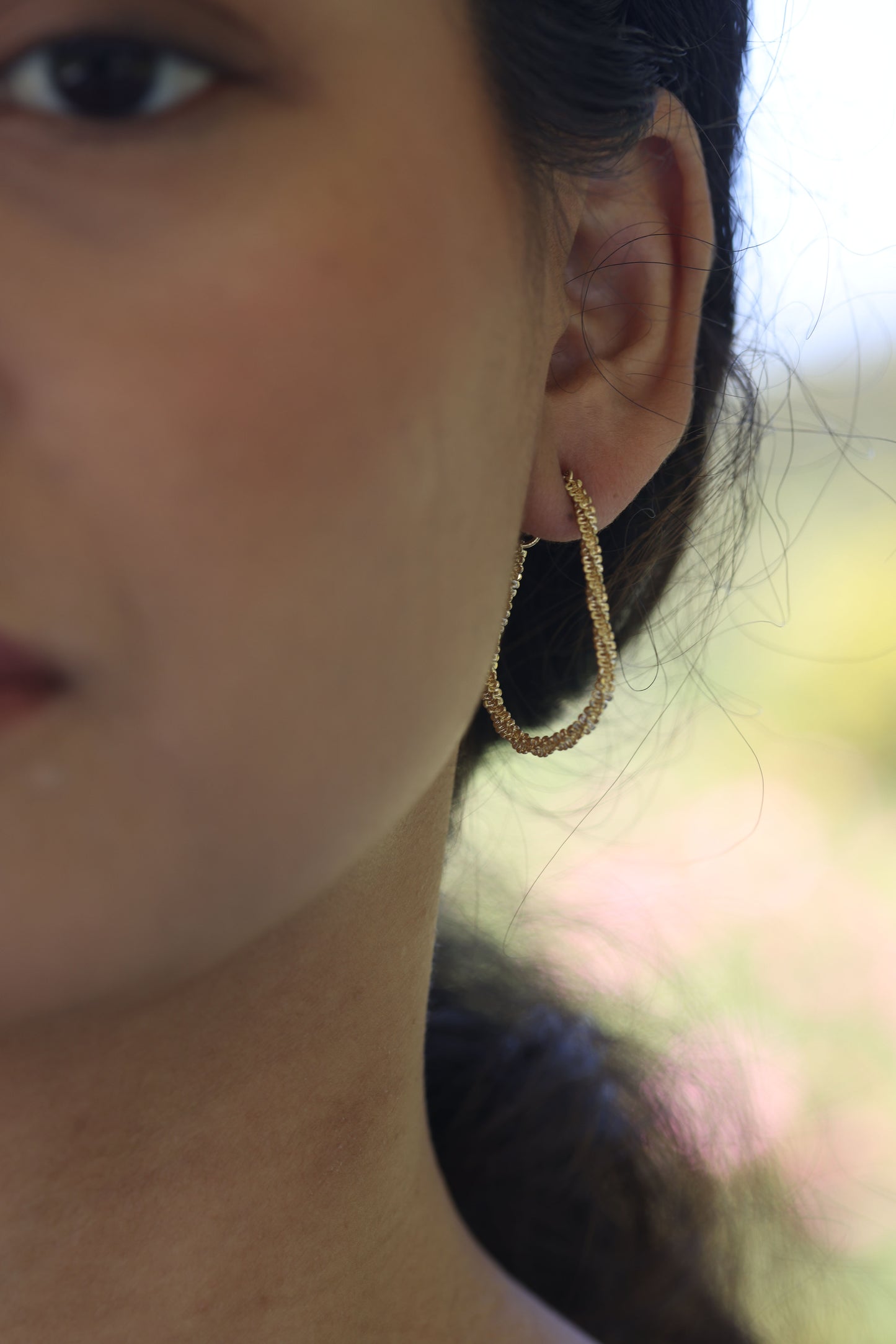 sparkle gold chain errings on an ear