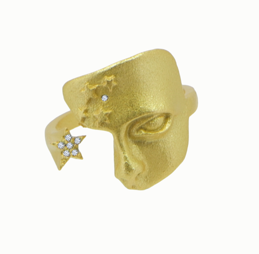 Gold ring with star designs on a white background