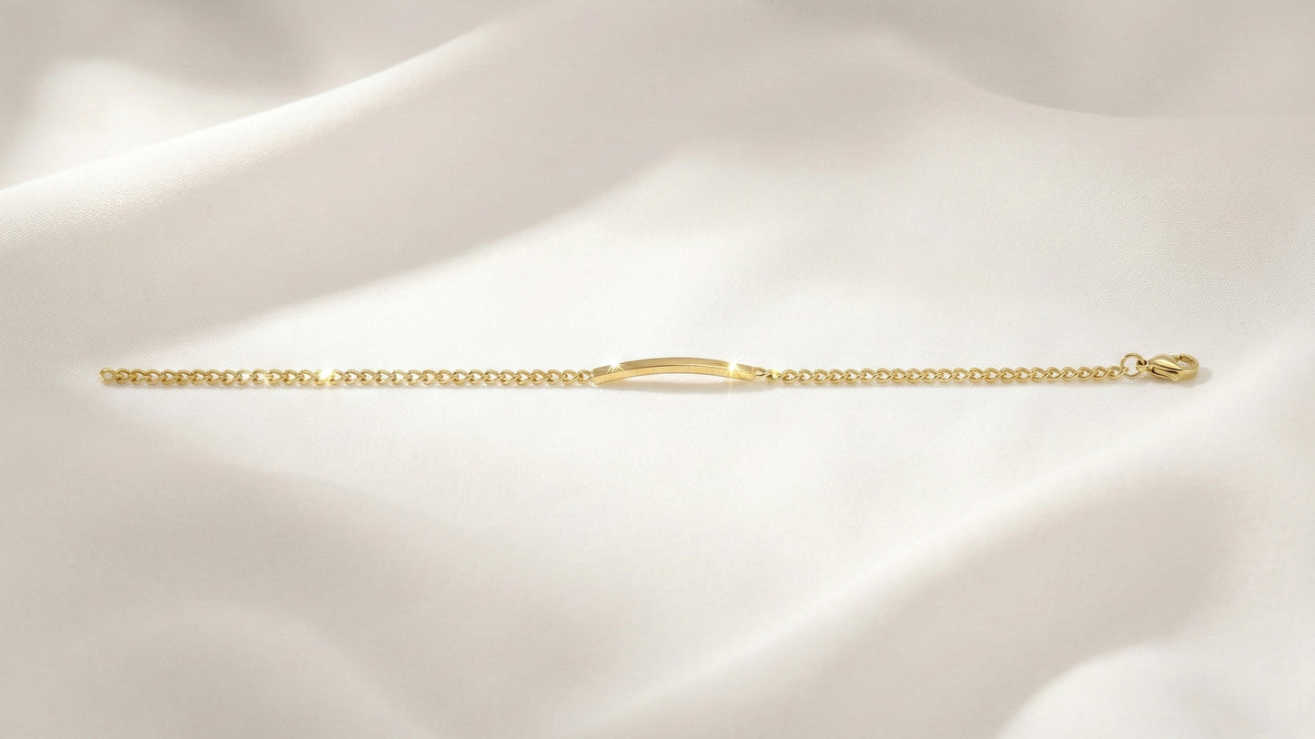 Gold chain bracelet on a soft beige background
