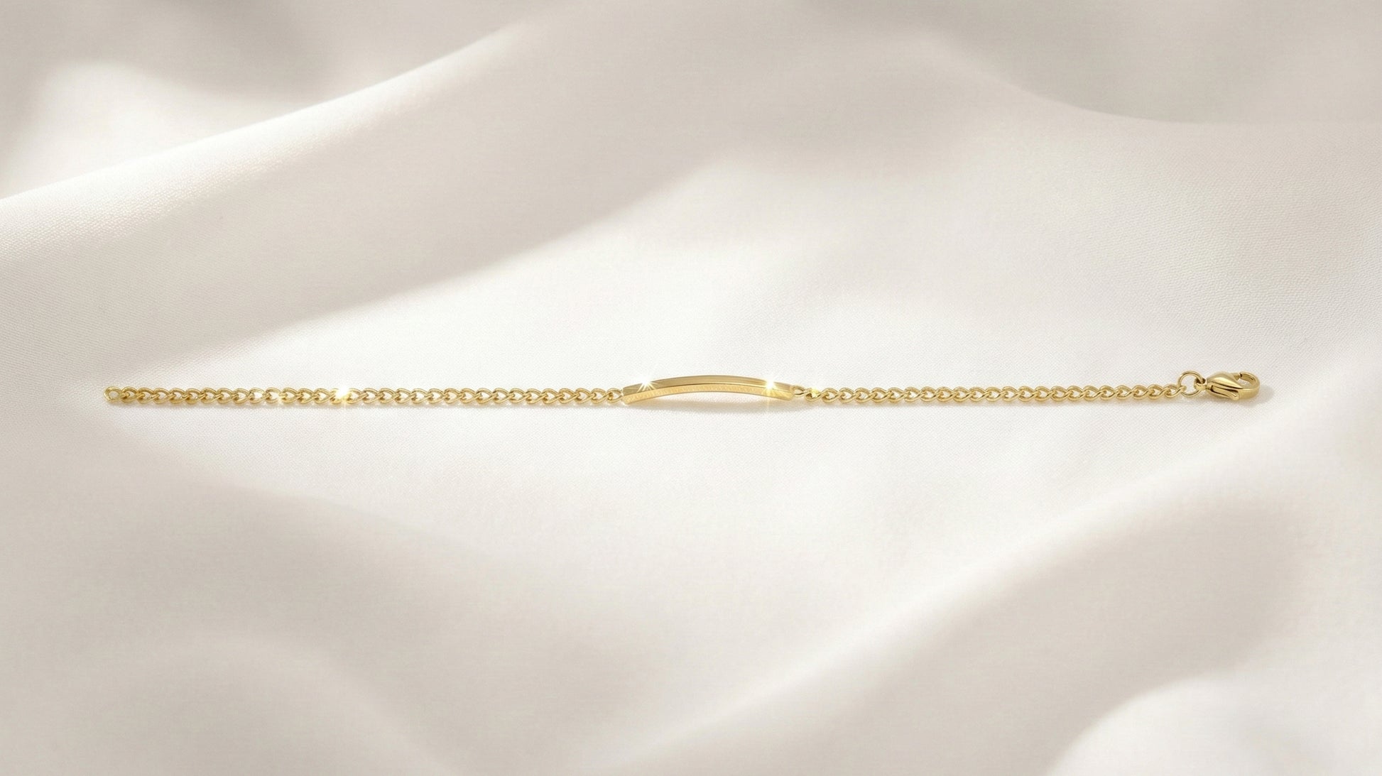 Gold chain bracelet on a soft beige background