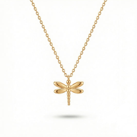 Gold dragonfly necklace on a white background