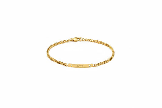 Gold bracelet with 'LOVE' engraving on a white background
