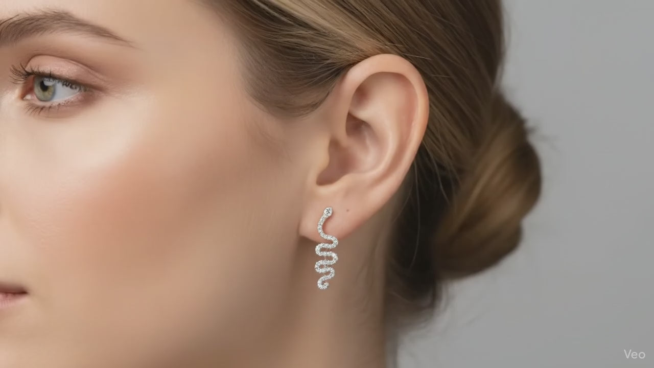 Close-up of an ear wearing a small  snake earring 