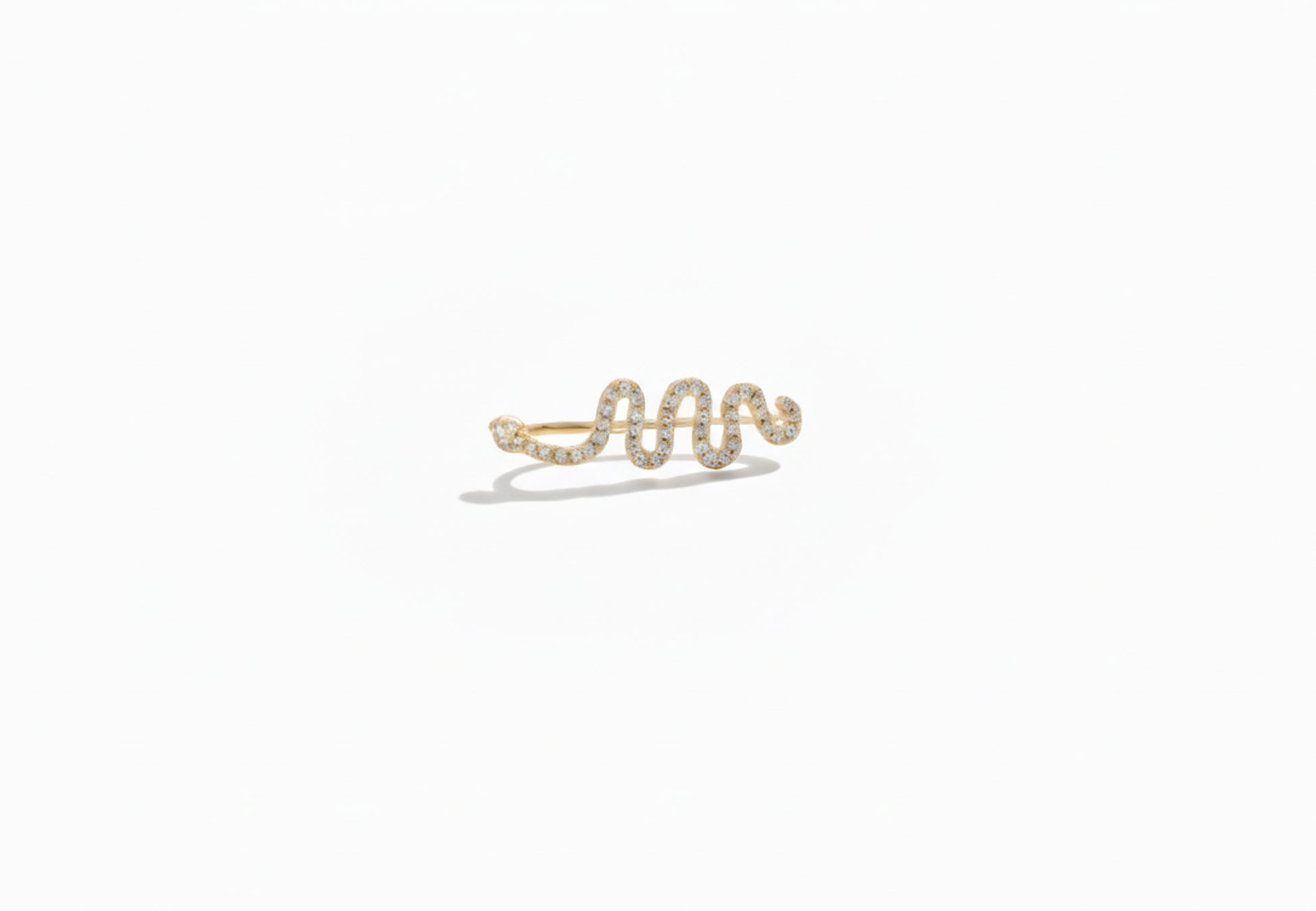 Gold snake-shaped eaRring on a white background