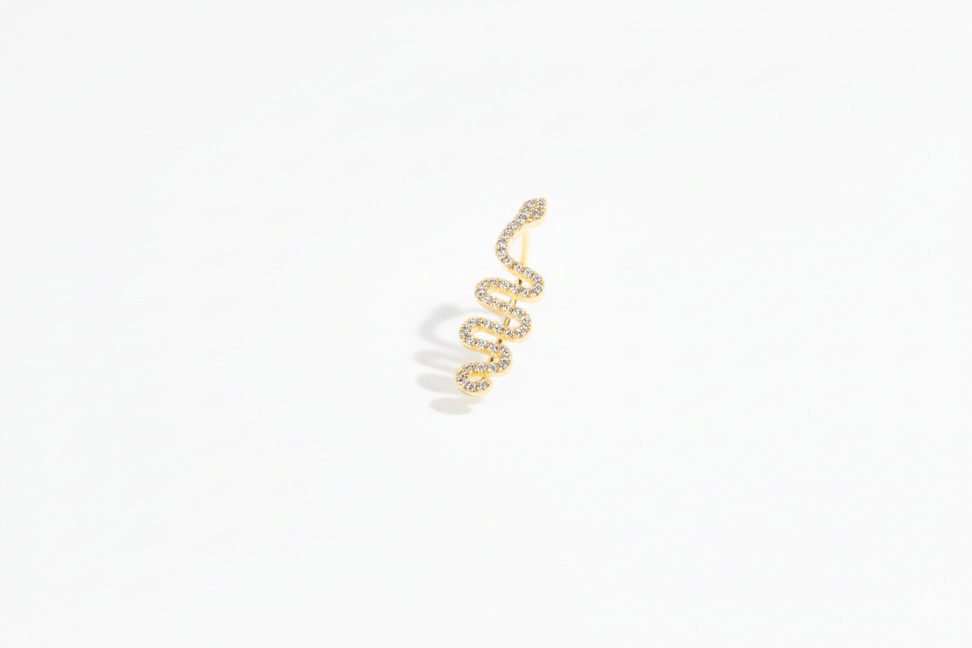 Gold snake earring on a white background