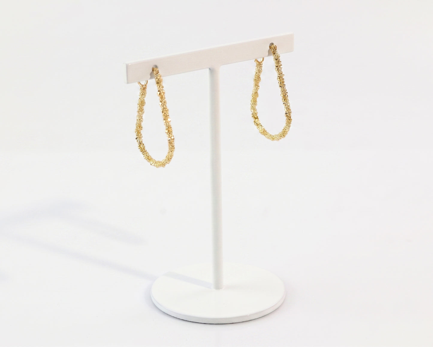 sparkle gold chain errings on a stand
